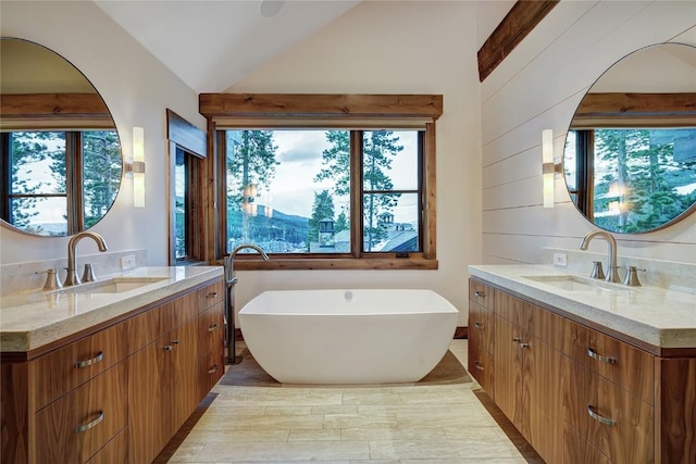 422 Timber Trail Rd, Breckenridge, CO 80424 - full bathroom with a sink, a soaking tub, vaulted ceiling, and two vanities