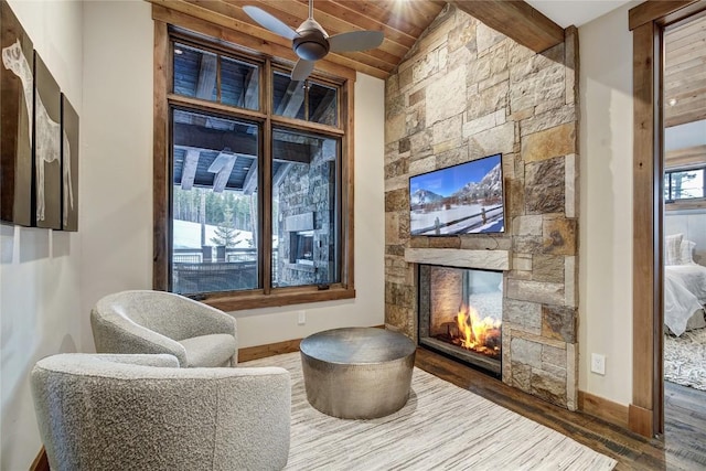422 Timber Trail Rd, Breckenridge, CO 80424 - living area featuring a ceiling fan, wood finished floors, a fireplace, wood ceiling, and lofted ceiling with beams