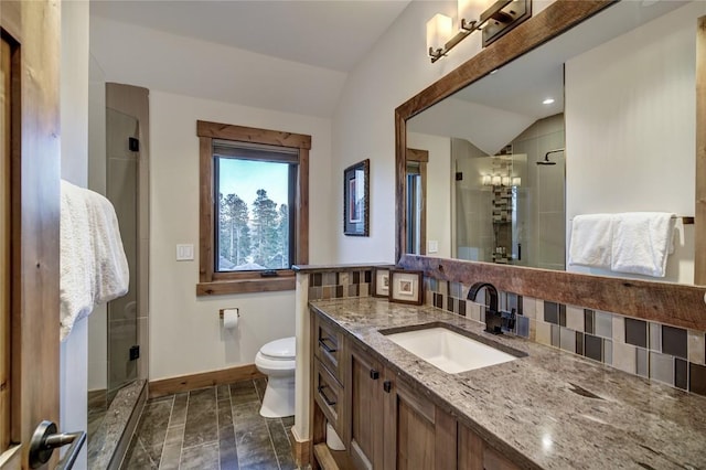 422 Timber Trail Rd, Breckenridge, CO 80424 - bathroom featuring vanity, baseboards, decorative backsplash, a shower stall, and vaulted ceiling