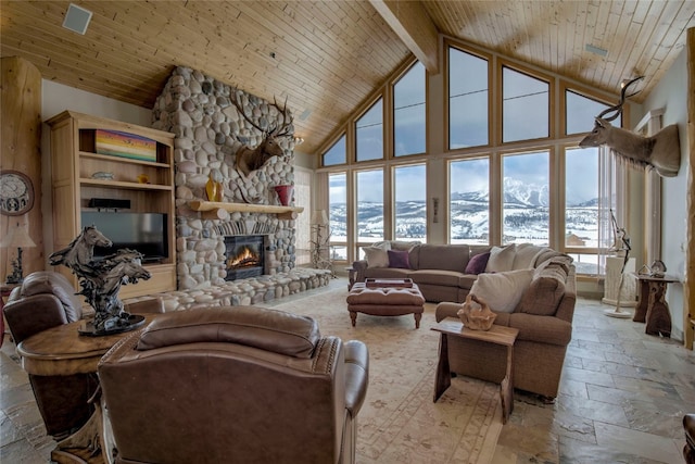 1235 Elk Run Rd, Silverthorne, CO 80498 - living room with high vaulted ceiling, plenty of natural light, a stone fireplace, stone tile floors, and beam ceiling