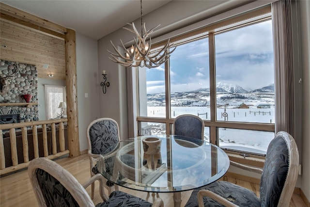 1235 Elk Run Rd, Silverthorne, CO 80498 - dining room featuring a chandelier, light wood-style floors, and a mountain view
