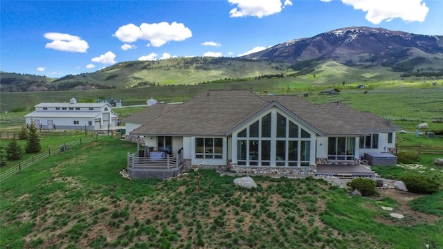 1235 Elk Run Rd, Silverthorne, CO 80498 - rear view of house featuring a deck with mountain view, a sunroom, and a rural view
