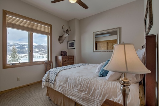 1235 Elk Run Rd, Silverthorne, CO 80498 - carpeted bedroom with multiple windows, baseboards, ceiling fan, and a mountain view