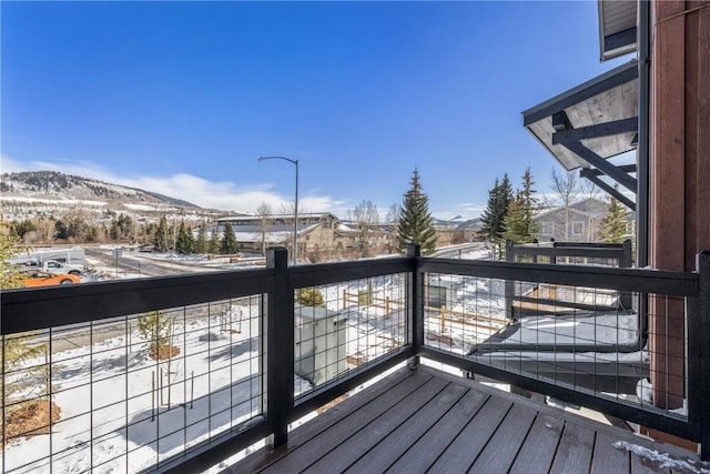 snow covered deck featuring a mountain view