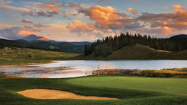 23110 US Highway 6 Unit 5054, Keystone, CO 80435 - view of community featuring a water and mountain view, a putting area, and view of golf course