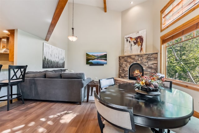24 Rasor Dr Unit 24, Keystone, CO 80435 - dining room featuring high vaulted ceiling, a stone fireplace, beam ceiling, and wood finished floors