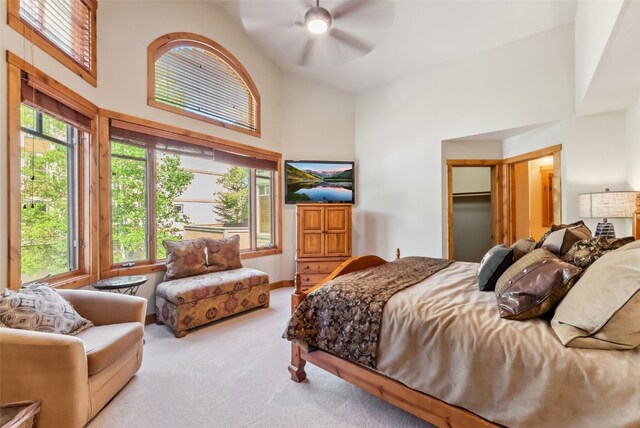 24 Rasor Dr Unit 24, Keystone, CO 80435 - carpeted bedroom with multiple windows, high vaulted ceiling, a ceiling fan, and a walk in closet