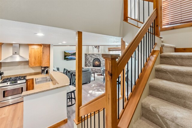24 Rasor Dr Unit 24, Keystone, CO 80435 - staircase with a lit fireplace, wood finished floors, and recessed lighting