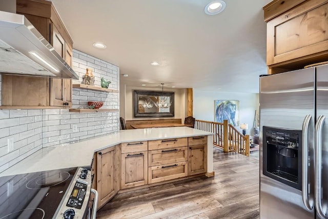 422 Kings Crown Rd Unit 5, Breckenridge, CO 80424 - kitchen with dark wood-style floors, stainless steel appliances, open shelves, wall chimney exhaust hood, and a peninsula