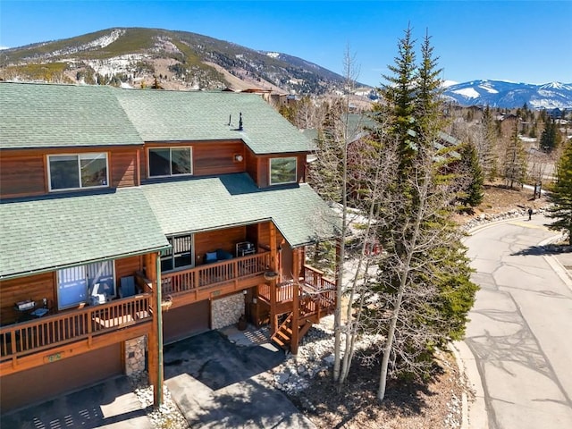 60 Lookout Ridge Dr, Dillon, CO 80435 - back of property featuring a garage, a shingled roof, and a deck with mountain view