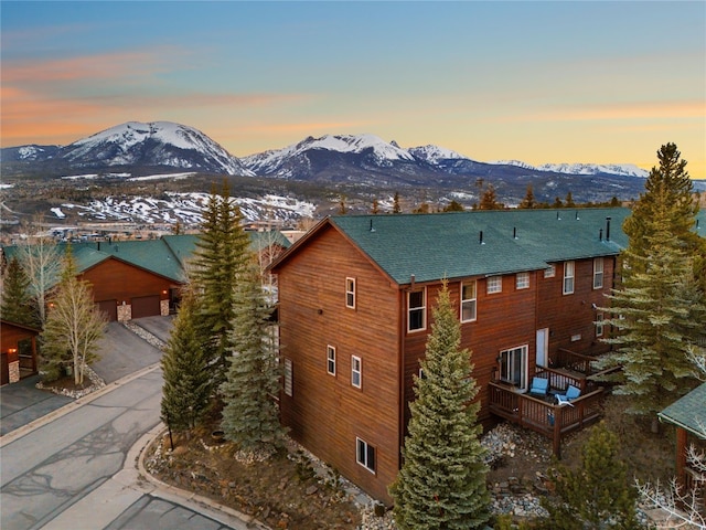 60 Lookout Ridge Dr, Dillon, CO 80435 - view of side of home featuring a garage, roof with shingles, and a deck with mountain view