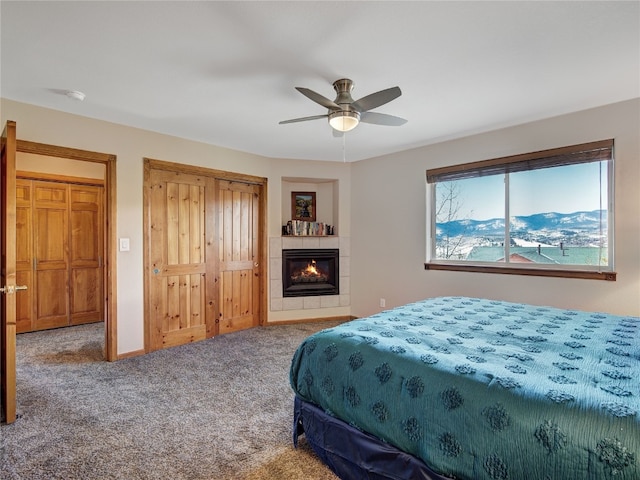 60 Lookout Ridge Dr, Dillon, CO 80435 - carpeted bedroom with a tiled fireplace, a ceiling fan, baseboards, and a closet