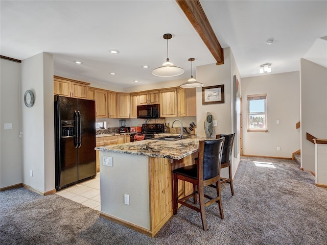 60 Lookout Ridge Dr, Dillon, CO 80435 - kitchen featuring light stone counters, a peninsula, black appliances, and light carpet