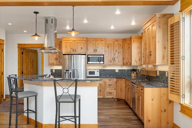 121 Shekel Ln, Breckenridge, CO 80424 - kitchen featuring appliances with stainless steel finishes, island range hood, wood finished floors, a kitchen bar, and recessed lighting