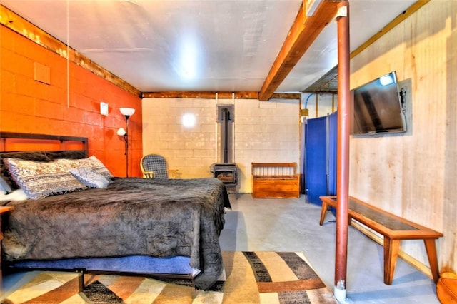 262 Swandyke Ct, Jefferson, CO 80456 - bedroom featuring concrete flooring, a wood stove, and concrete block wall