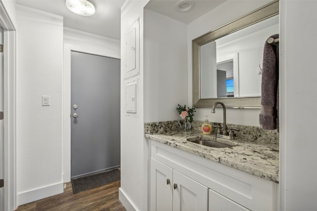 bathroom featuring baseboards, vanity, and wood finished floors