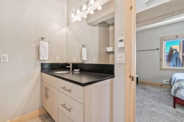 2650 Medicine Springs Dr Unit 11, Steamboat Springs, CO 80487 - bathroom with a baseboard heating unit, vanity, baseboards, and connected bathroom