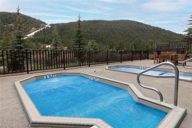 22714 US Highway 6 Unit 5958, Keystone, CO 80435 - community pool with a wooded view, a mountain view, and a patio