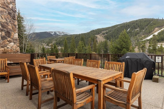 22714 US Highway 6 Unit 5958, Keystone, CO 80435 - view of patio / terrace featuring a mountain view, a grill, outdoor dining space, and a forest view