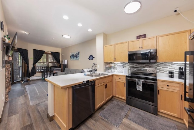 22714 US Highway 6 Unit 5958, Keystone, CO 80435 - kitchen with stainless steel appliances, a sink, light brown cabinetry, open floor plan, and a peninsula