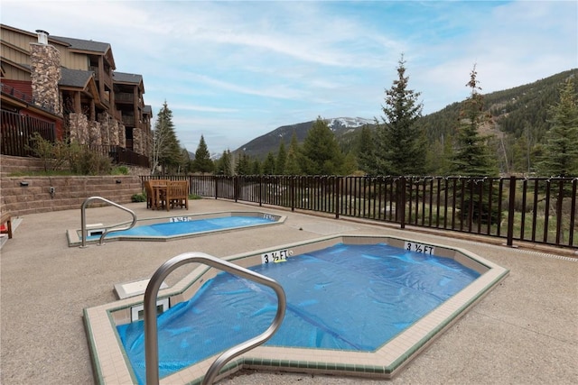 22714 US Highway 6 Unit 5958, Keystone, CO 80435 - view of swimming pool featuring a mountain view, a patio, and a jacuzzi