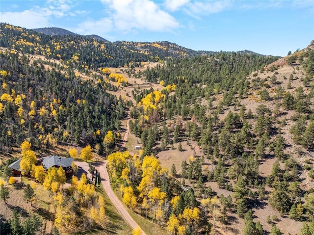 aerial view featuring a view of trees and a mountain view