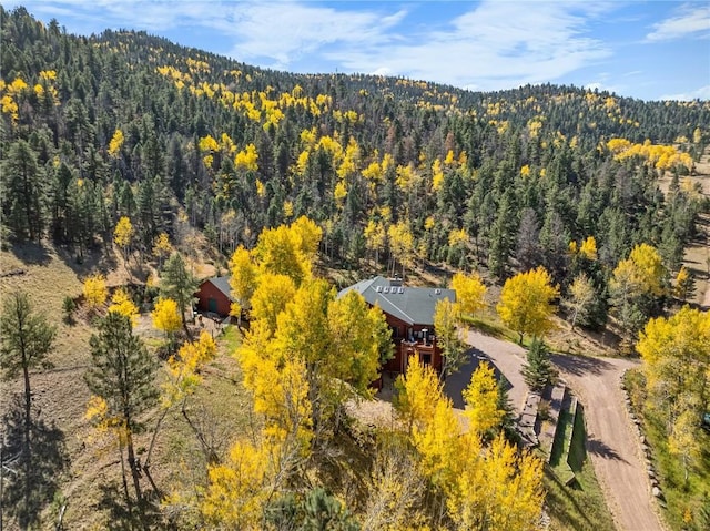 drone / aerial view featuring a forest view