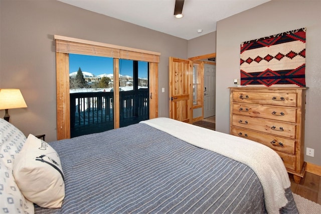 164 Buck Ridge Rd Unit 164, Summit Cove, CO 80435 - bedroom with access to exterior, wood finished floors, and ceiling fan