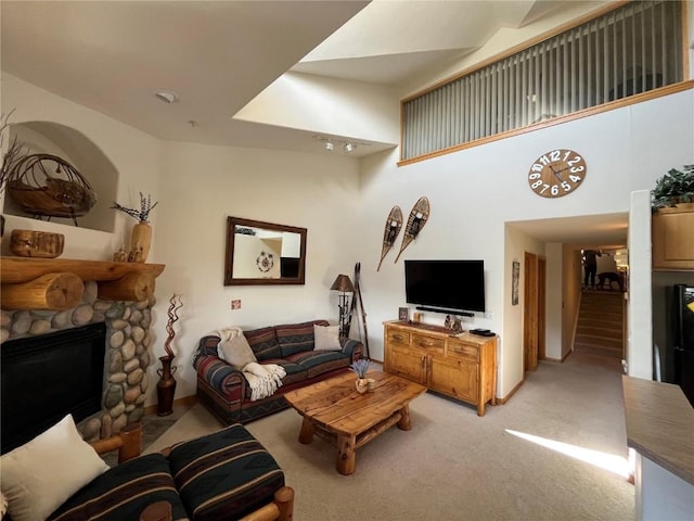 91399 Ryan Gulch Rd Unit B3, Silverthorne, CO 80498 - living area featuring light colored carpet, a stone fireplace, and stairway