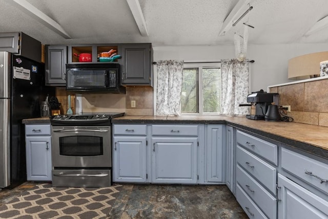 21490 2nd Ave, Milner, CO 80487 - kitchen featuring black microwave, electric range, freestanding refrigerator, a textured ceiling, and decorative backsplash