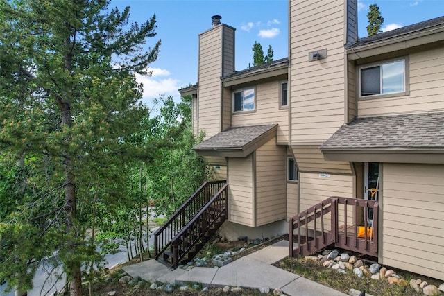 6941 Ryan Gulch Rd Unit 6941, Silverthorne, CO 80498 - exterior space featuring a chimney and a shingled roof