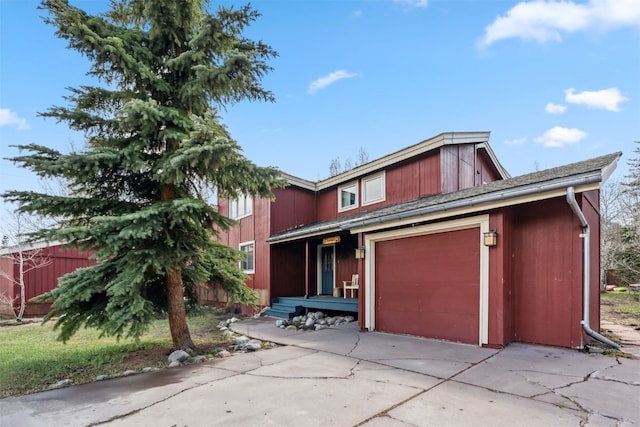 traditional home with fence, an attached garage, and driveway
