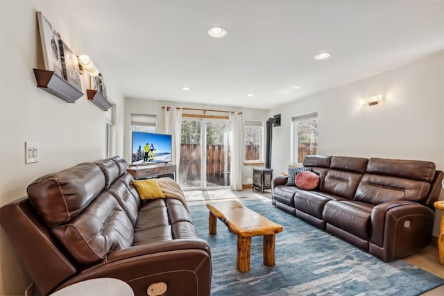living room with recessed lighting and a wood stove