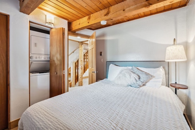 bedroom featuring wood ceiling, stacked washer / drying machine, and beam ceiling
