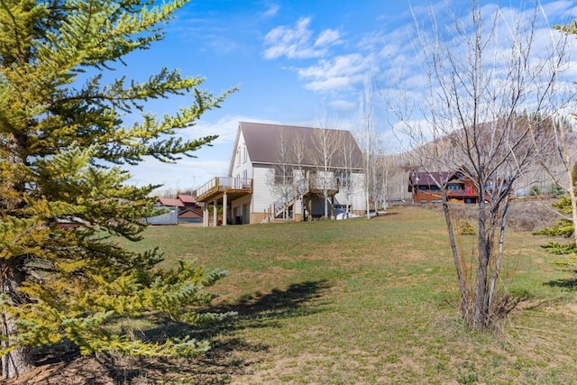 57680 Saturn Ct, Clark, CO 80428 - back of house with a wooden deck, stairway, and a yard