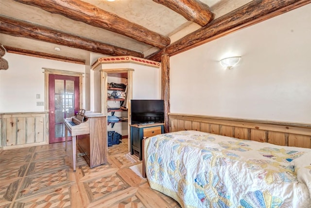 61020 County Road 129, Hahns Peak, CO 80428 - bedroom with wainscoting and beam ceiling