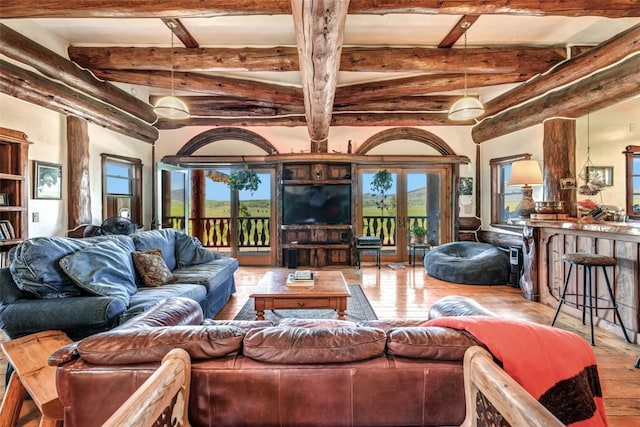 61020 County Road 129, Hahns Peak, CO 80428 - living area featuring hardwood / wood-style flooring, healthy amount of natural light, beam ceiling, and french doors