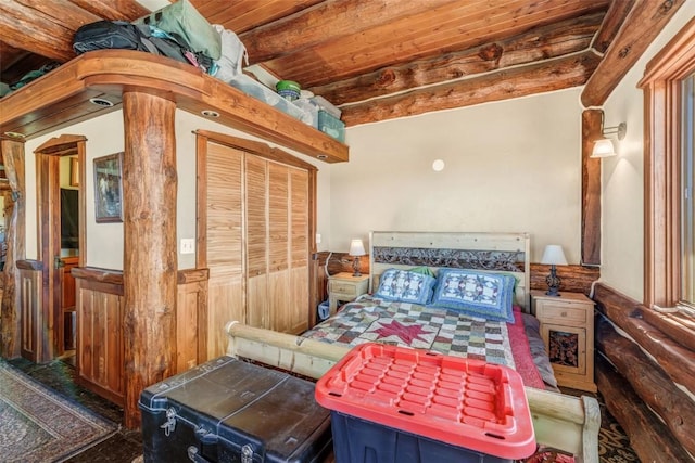 61020 County Road 129, Hahns Peak, CO 80428 - bedroom featuring wood ceiling, a wainscoted wall, beam ceiling, and a closet