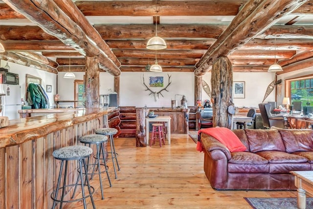 61020 County Road 129, Hahns Peak, CO 80428 - living room with beamed ceiling, light wood finished floors, and bar area