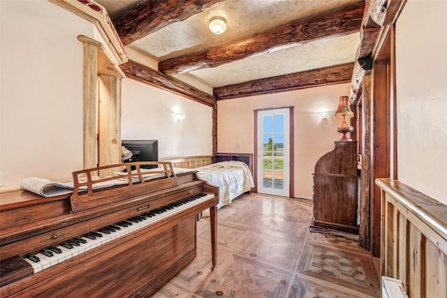 61020 County Road 129, Hahns Peak, CO 80428 - bedroom with beam ceiling, access to exterior, and wainscoting