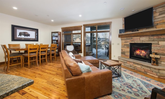 310 S 8th Ave Unit 4, Frisco, CO 80443 - living area with hardwood / wood-style flooring, a stone fireplace, and recessed lighting