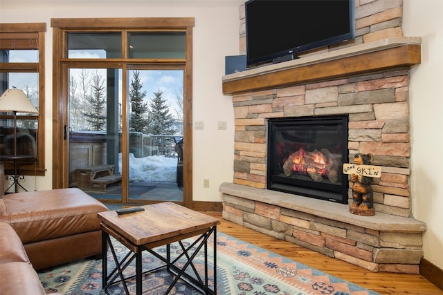 310 S 8th Ave Unit 4, Frisco, CO 80443 - living area featuring a fireplace, wood finished floors, a wealth of natural light, and baseboards