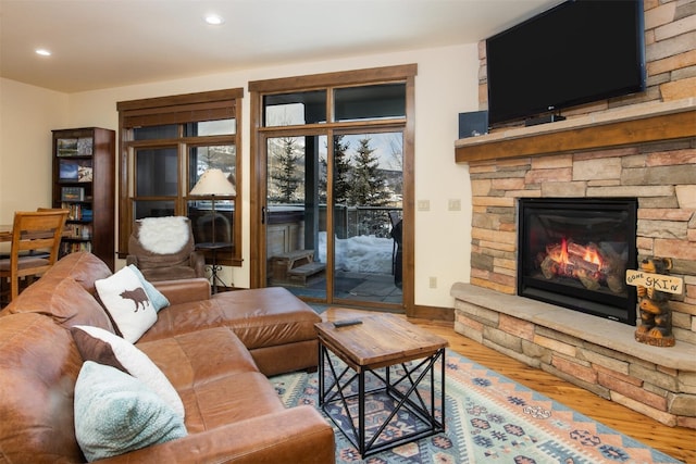 310 S 8th Ave Unit 4, Frisco, CO 80443 - living area featuring baseboards, a stone fireplace, wood finished floors, and recessed lighting