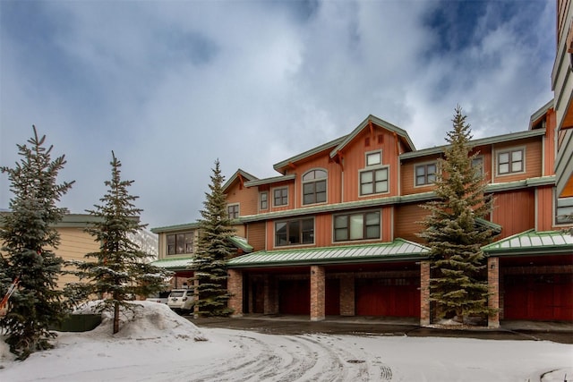 310 S 8th Ave Unit 4, Frisco, CO 80443 - view of front facade with an attached garage, metal roof, and covered porch