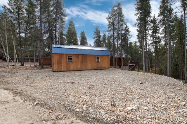 view of outdoor structure with an outdoor structure and a view of trees