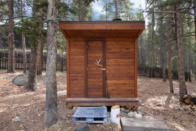 view of shed featuring fence