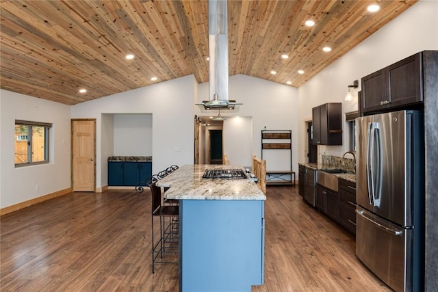 kitchen with a sink, a breakfast bar area, lofted ceiling, appliances with stainless steel finishes, and recessed lighting