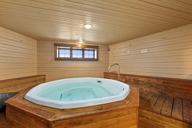 misc room with wood walls, a jacuzzi, and wooden ceiling