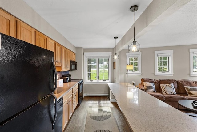 kitchen with dark wood-style floors, pendant lighting, black appliances, a baseboard radiator, and open floor plan
