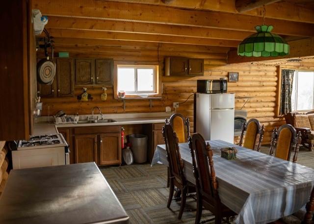 80 Sapling Ln, Craig, CO 81625 - dining room with log walls and healthy amount of natural light
